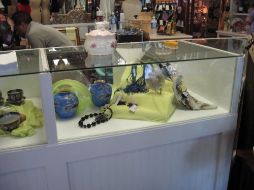 Here, home decor and beads are arranged on colorfully-draped risers.