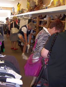 Clustomers in a consignment shop. The "catch" of the day? Shoes!