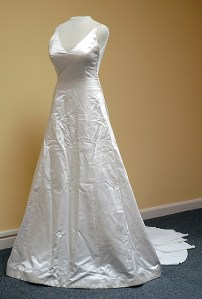 Wrinkled wedding gown in a resale shop