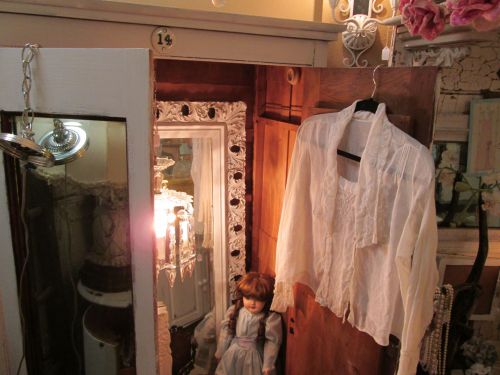 Another ajar armoire (say that 3 times fast!), this time with a small table lamp, a mirror, and more. Makes each piece look SO much more interesting and desirable. Now that's using all your space!